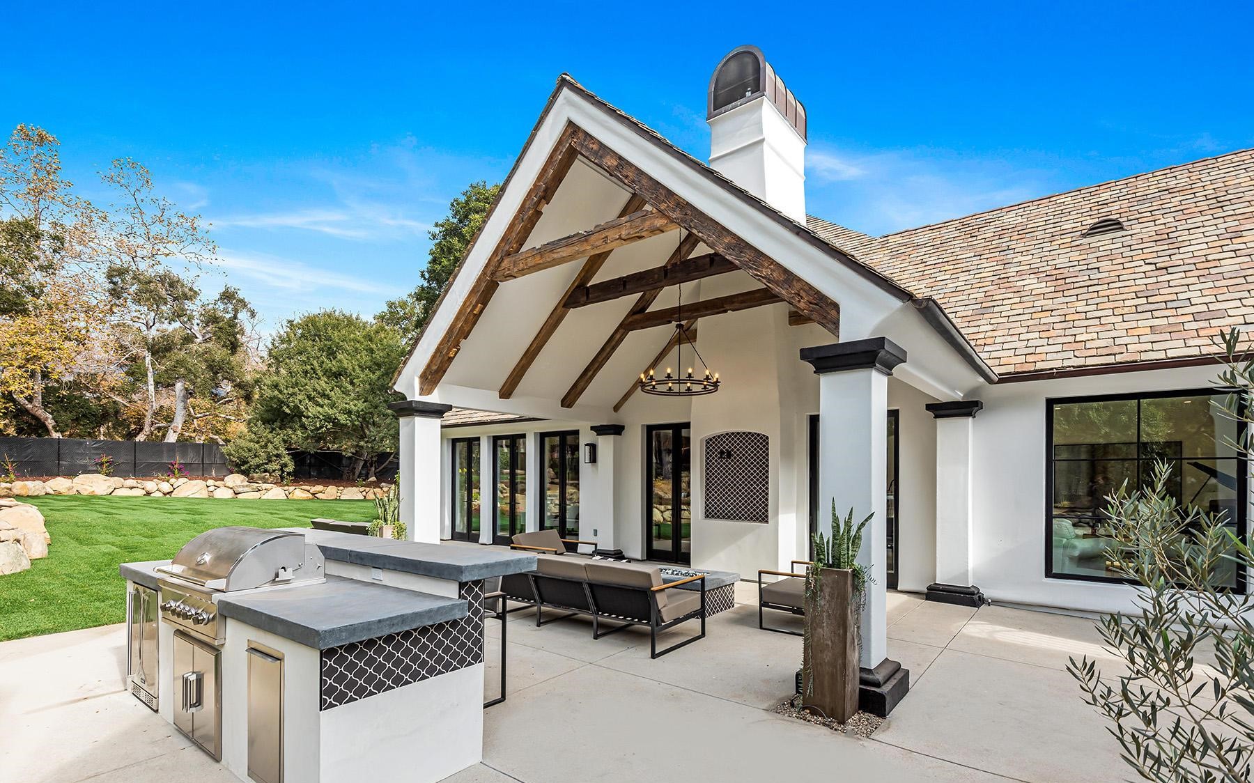 Covered outdoor living pavilion with kitchen and lounge